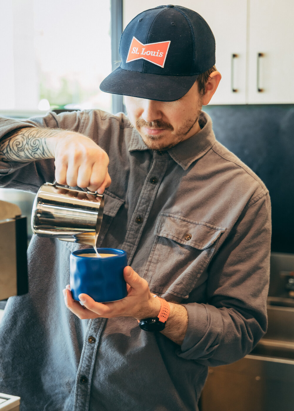 Pouring latte art at Essere Caffè